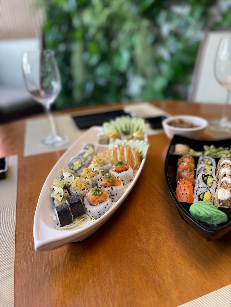Mesa posta com barca de peças frias da culinária japonesa